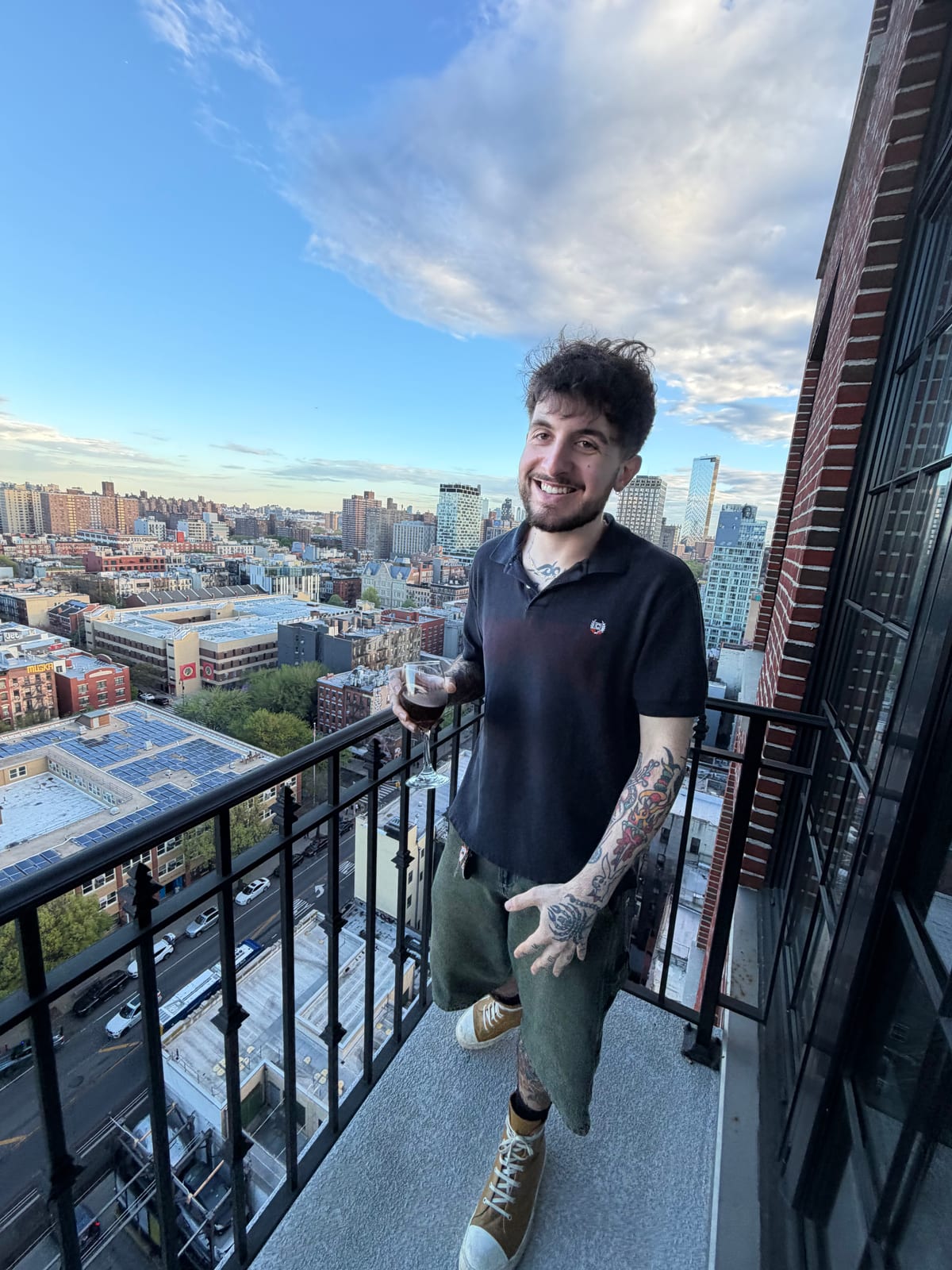 Andres standing on a city balcony